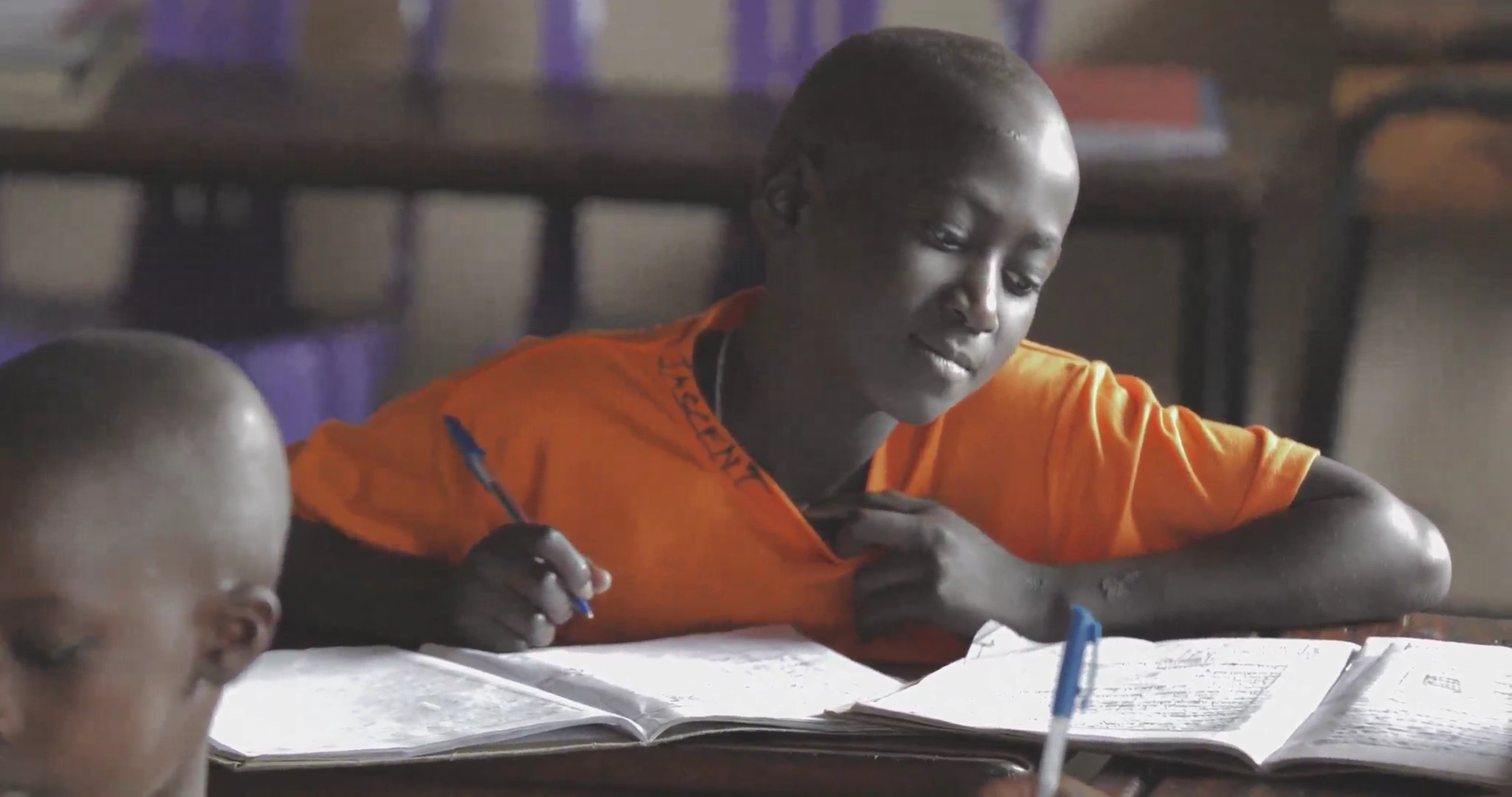 Girl in yellow uniform studying