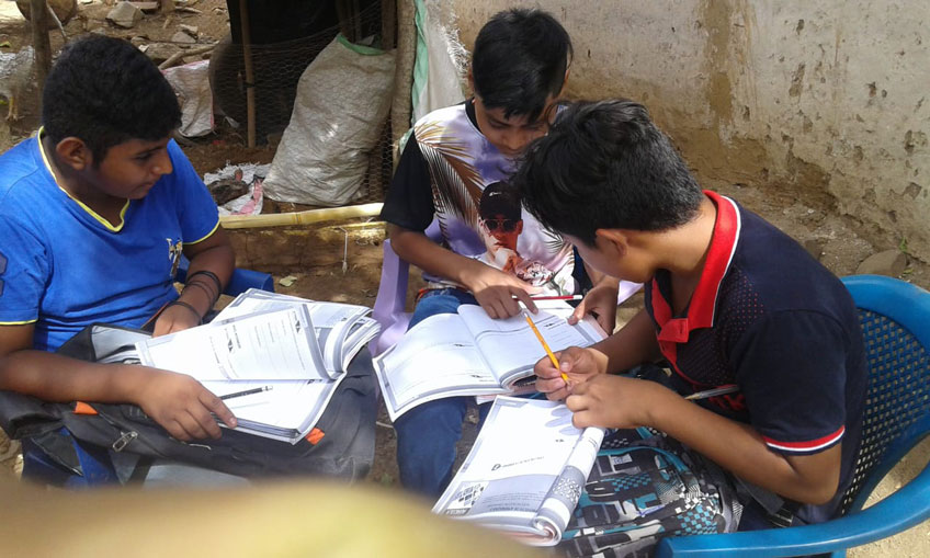 Three boys do homework together