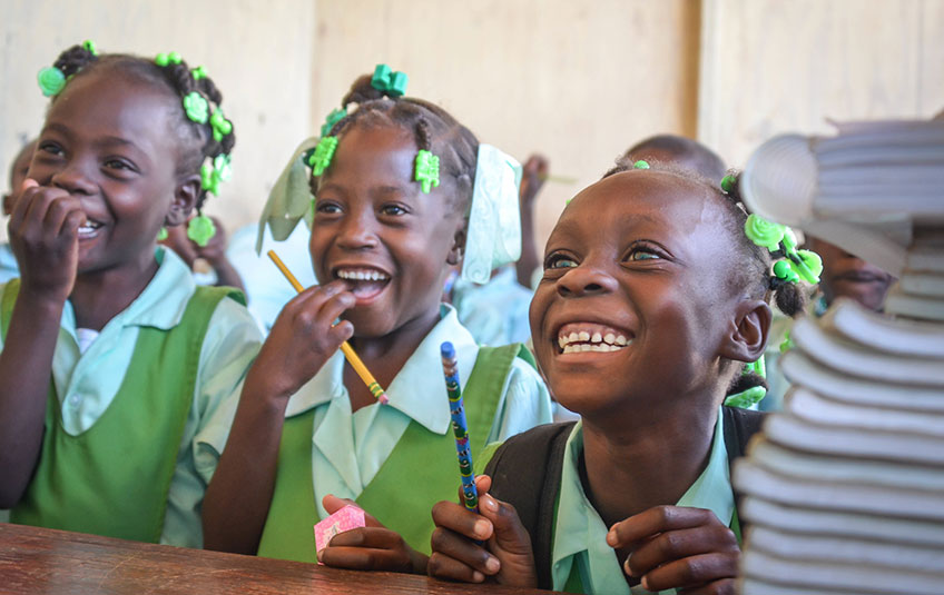 three schoolgirls smiling