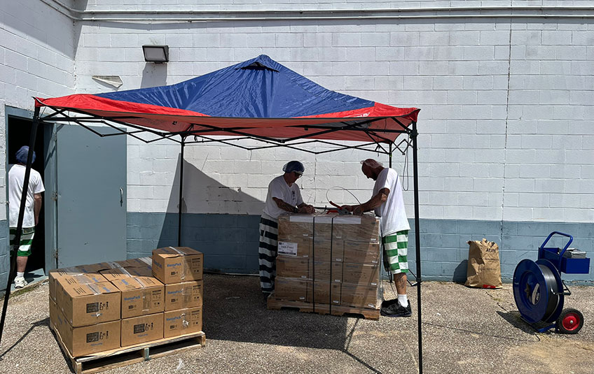 two men palletize boxes of FMSC food