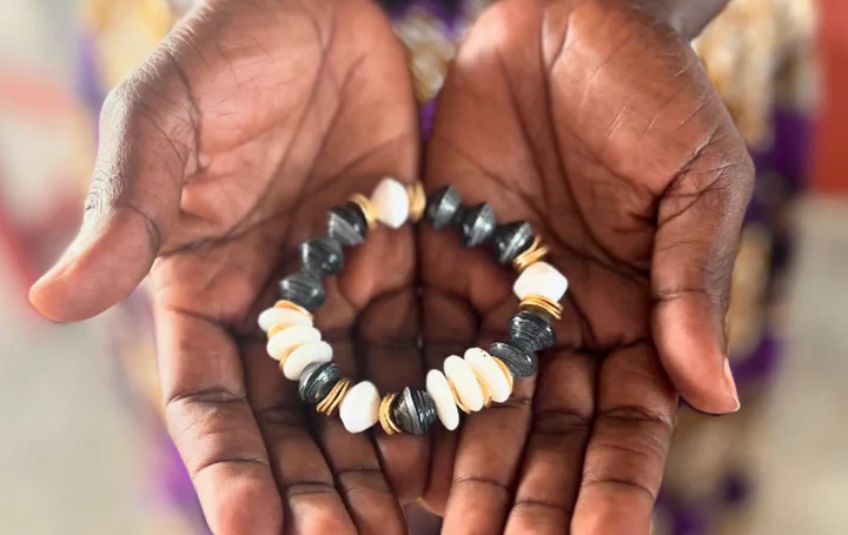 FMSC Marketplace Artisan holding Amari bracelet. 