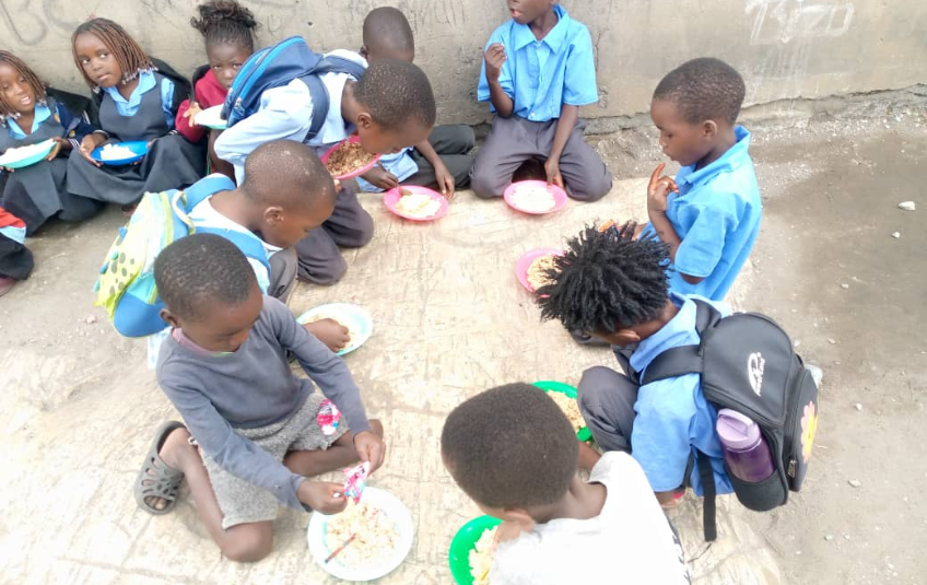 Kids eating at Free Baptist Community School 