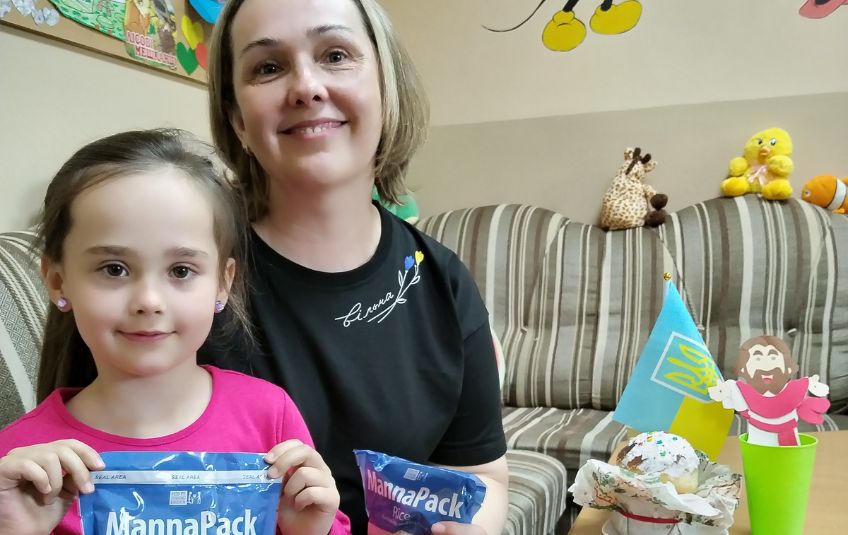 Olena and her daughter holding MannaPack.