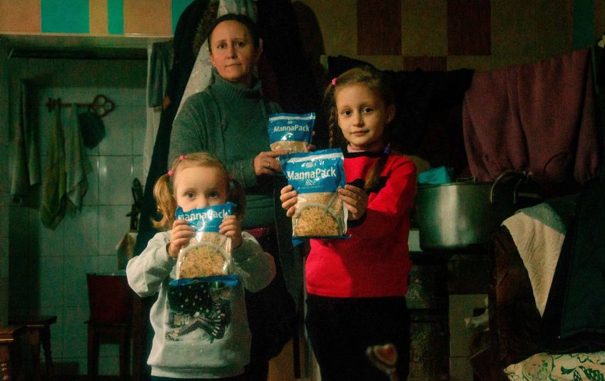 Family of refugees with MannaPack Rice.