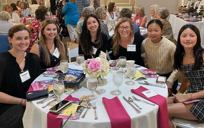 Ladies smiling at their table at Ripples of Hope. 