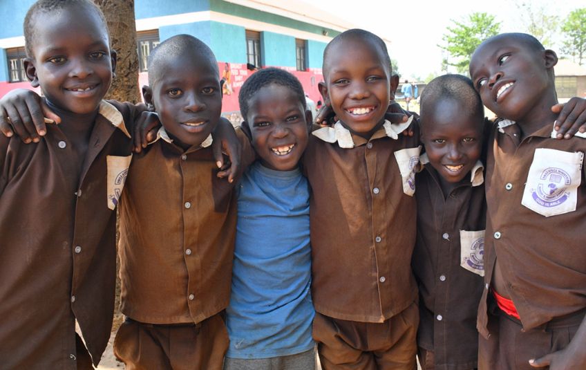 6 kids in uniforms smiling