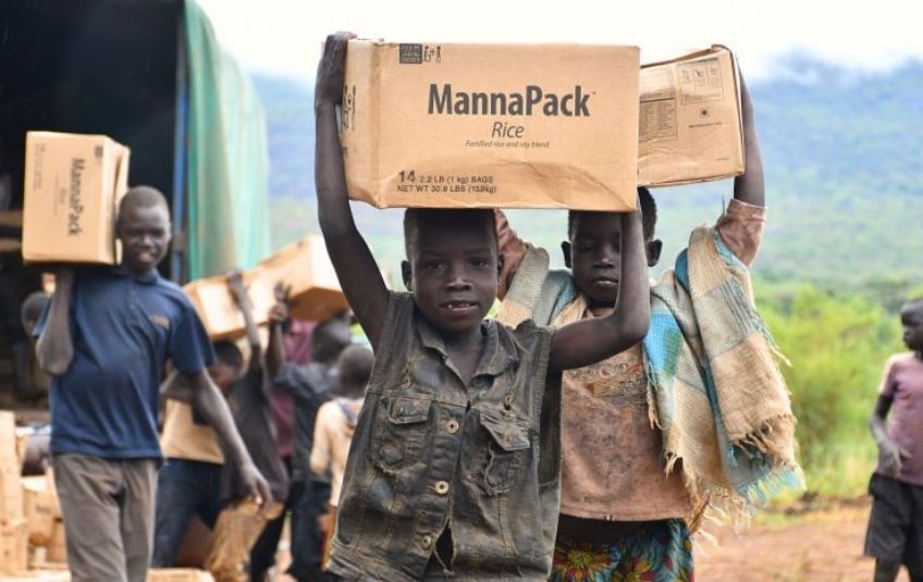 boys carrying FMSC boxes on their heads