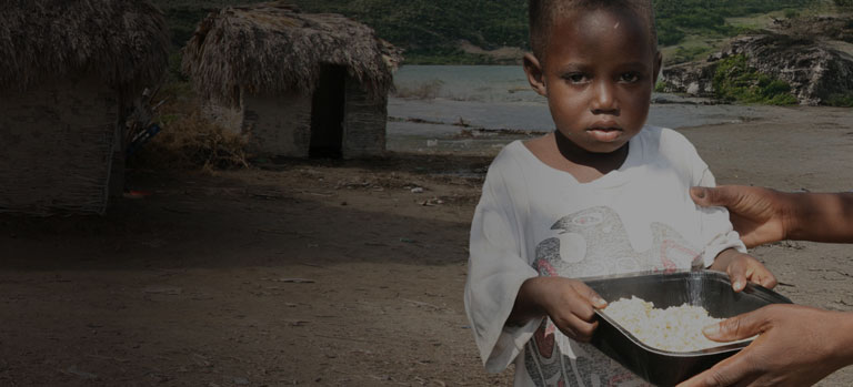 A child holding a bowl of FMSC food