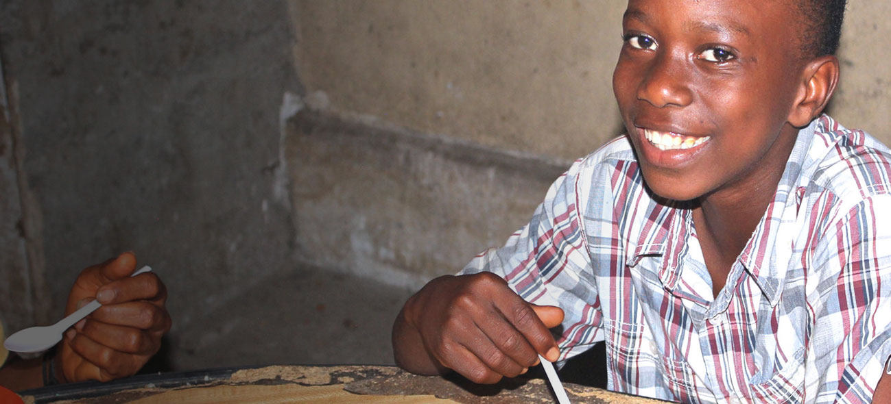 A child at a table eating FMSC food